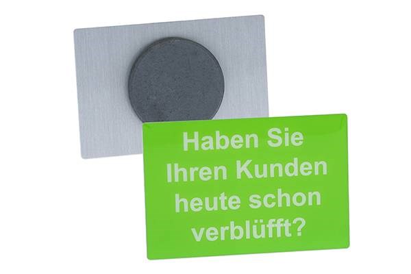 Dienstleister: Der Magnet - Pin wird wie ein Ansteck- Pin hergestellt, hat aber auf der Rückseite einen schwarzen Gussmagneten befestigt. Lieferung erfolgt ab 100 Stück. - Pins & mehr GmbH & Co.KG